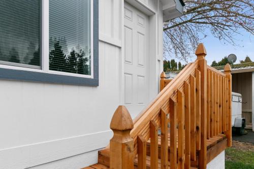 A wooden railing on the side of a mobile home.