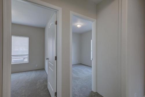 An empty room with a door leading to another room.