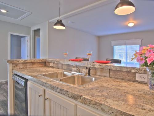 A kitchen with granite counter tops and a sink.