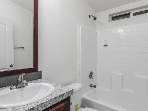 A white bathroom with a toilet and sink.