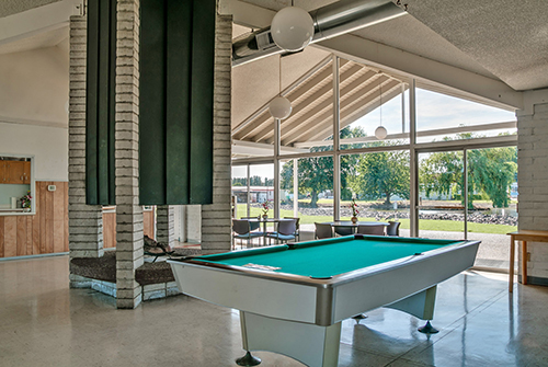 A pool table in a living room.